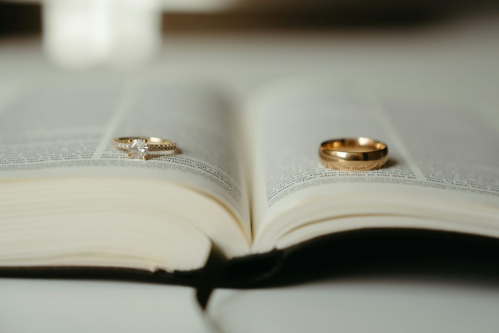 Wedding rings laying on an open book